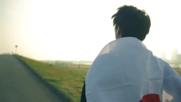 Inspirierender japanischer Läufer hält seine japanische Nationalflagge in der Hand — Stockvideo