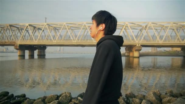 Young Japanese Runner Shadow Boxing at the river after big run warm down — Stock Video