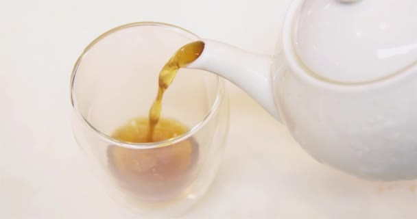 Pouring fresh cup of tea from the kettle