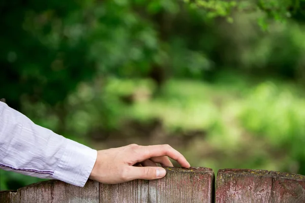 Human hand on Wooden fence — Stock Photo, Image