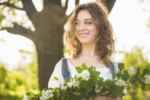 Mujer con ramas de cerezo florecientes — Foto de Stock