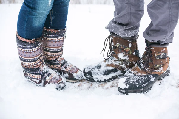 boots of young couple in forest