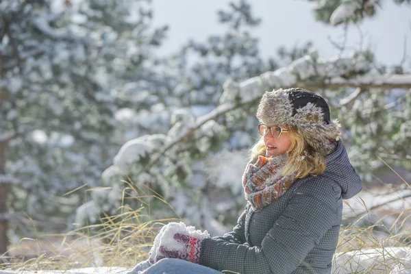 Kvinna sitter på snön — Stockfoto