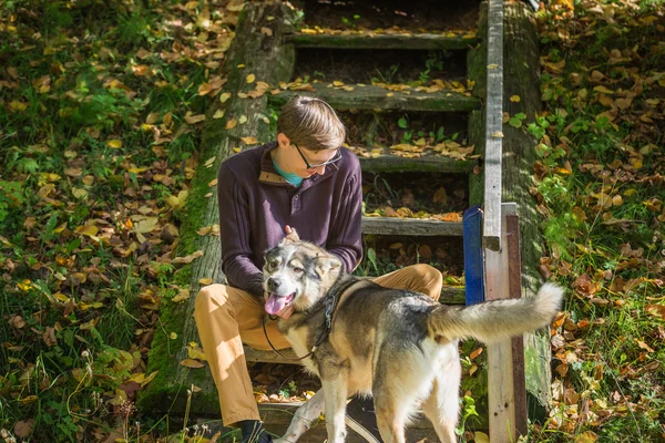 Hombre sentado en las escaleras con perro —  Fotos de Stock