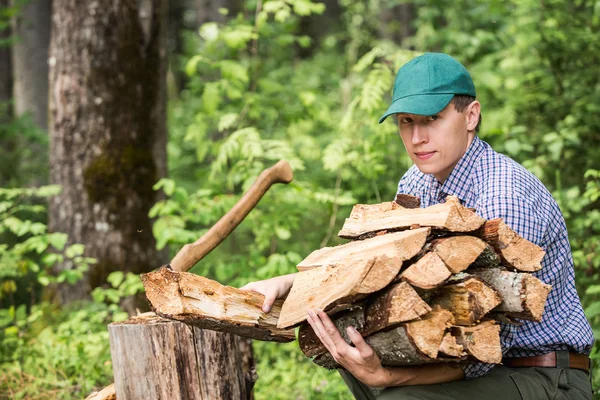 Man picking chopped wood — Stock Photo, Image