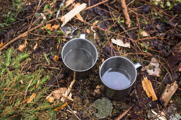 Metal mugs on the ground — Stock Photo, Image