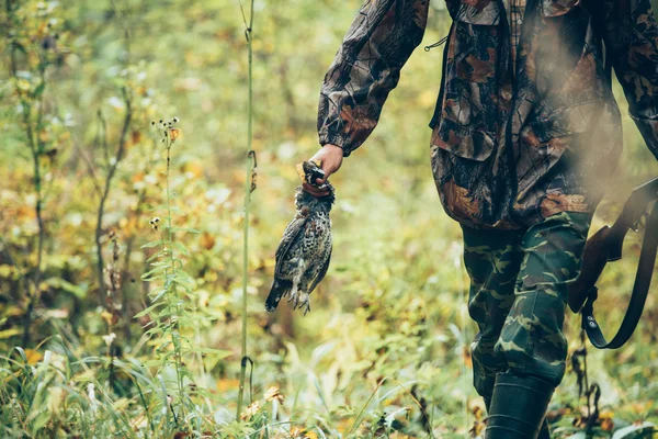 Male hunter holding grouse — Stock Photo, Image