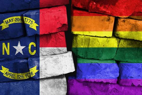 LGBT and State of North Carolina flag on brick wall