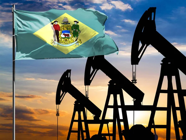 Oil rigs against the backdrop of the colorful sky and a flagpole with the flag State of Delaware. The concept of oil production, minerals, development of new deposits.
