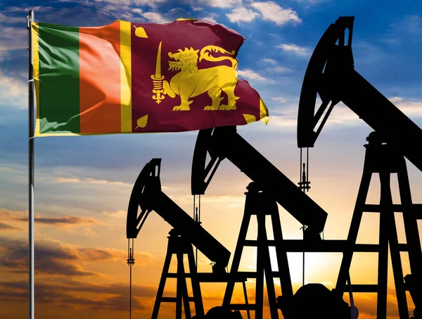 Oil rigs against the backdrop of the colorful sky and a flagpole with the flag of Sri Lanka. The concept of oil production, minerals, development of new deposits.