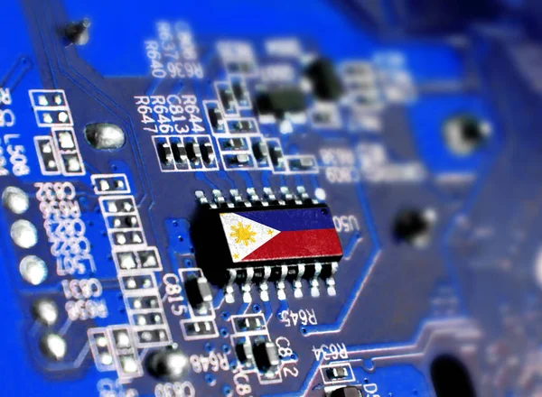 Electronic board with embedded microchip and shown flag of Philippines. The concept of modern computer technologies.
