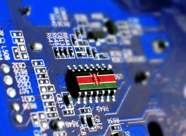 Electronic board with embedded microchip and shown flag of Kenya. The concept of modern computer technologies.