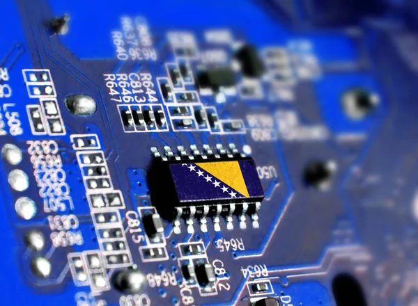 Electronic board with embedded microchip and shown flag of Bosnia and Herzegovina. The concept of modern computer technologies.
