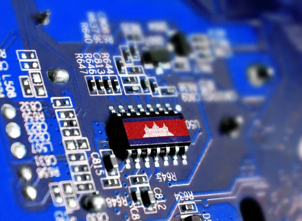Electronic board with embedded microchip and shown flag of Cambodia. The concept of modern computer technologies.