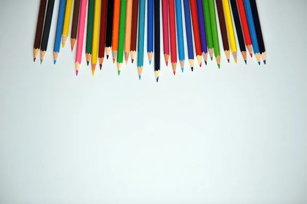 Colored pencils and shavings on a white background — Stock Photo, Image