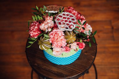 bir sandalyeyle bahar çiçekleri sepeti