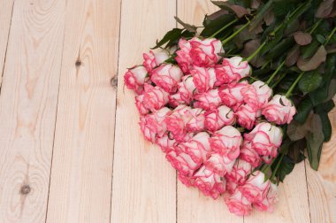 Koyu ahşap bir masa üzerinde güzel pembe güller