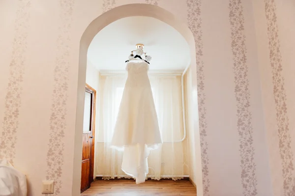 Belle robe de mariée blanche suspendue par la fenêtre — Photo
