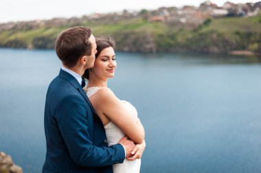 Gelin ve damat nehir kıyısında yürüyüş