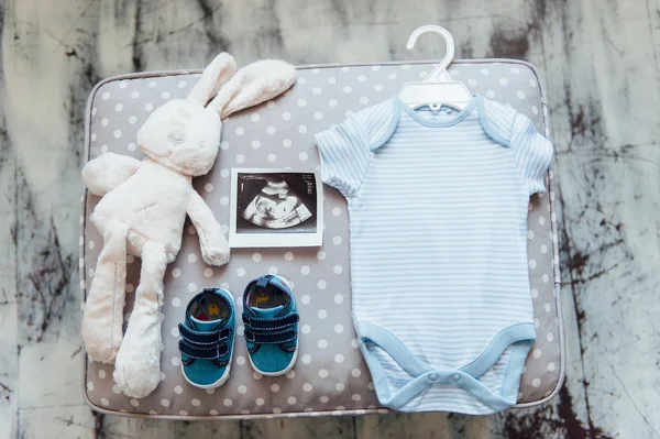 newborn baby clothes on textile background