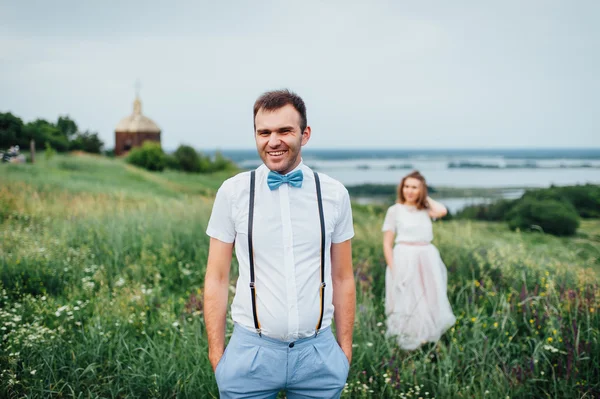 Šťastné nevěsty a ženicha na zelený trávník — Stock fotografie