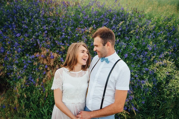 Lyckliga bruden och brudgummen gå på det gröna gräset — Stockfoto