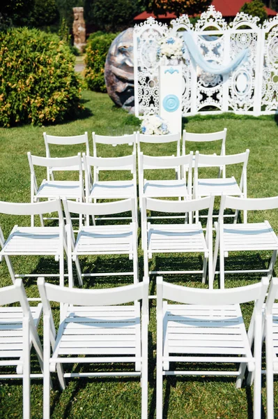 Rows of white folding chairs on lawn — Stock Photo, Image