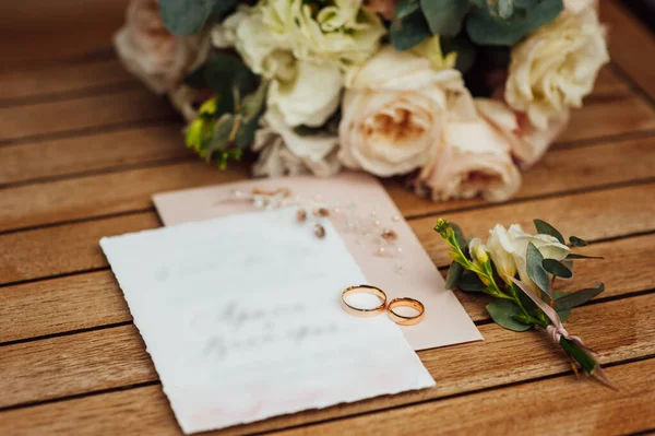 Лист запрошення на весілля для молодих гостей. Кільця і весільний букет лежать поруч — стокове фото