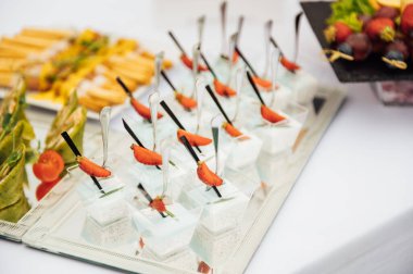 Sandviç, kanepe ve kekler festival masasında. Çok çeşitli atıştırmalıklar.