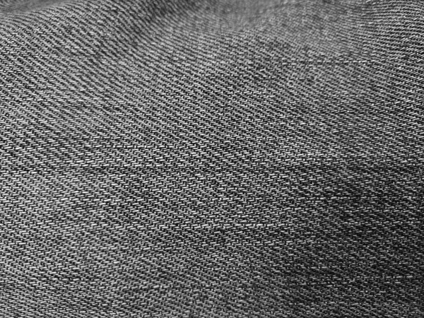 Dark denim background/texture in monochrome with selective focus — Stock Photo, Image