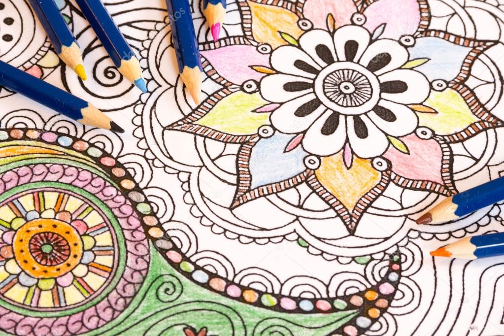 Adult colouring books with  pencils, new stress relieving trend, mindfulness concept person coloring  illustrative