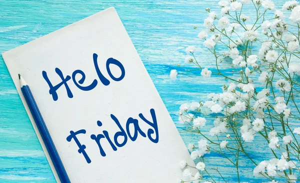 Hello Friday inspirational quotes lettering for postcards, business ideas, announcements, write a note with beautiful handwriting of a female hand notebook. wooden background