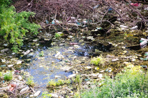 Desecho ilegal de residuos a granel. Vertedero en el río. medio ambiente contaminado. concepto de problema —  Fotos de Stock