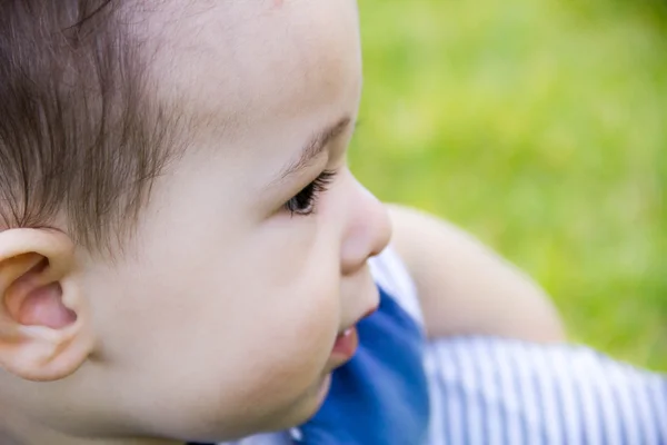 Close the face of the little toddler boy with a sly expression, which is going to be naughty. — Stock Photo, Image