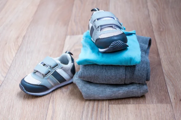 baby winter clothing, concept, autumn, sneakers, caps, toys. how to dress baby in winter. choose the shoes.