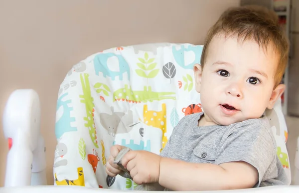 Small happy child sitting in a chair the concept of family, child health, feed the baby, eat at home — Stock Photo, Image