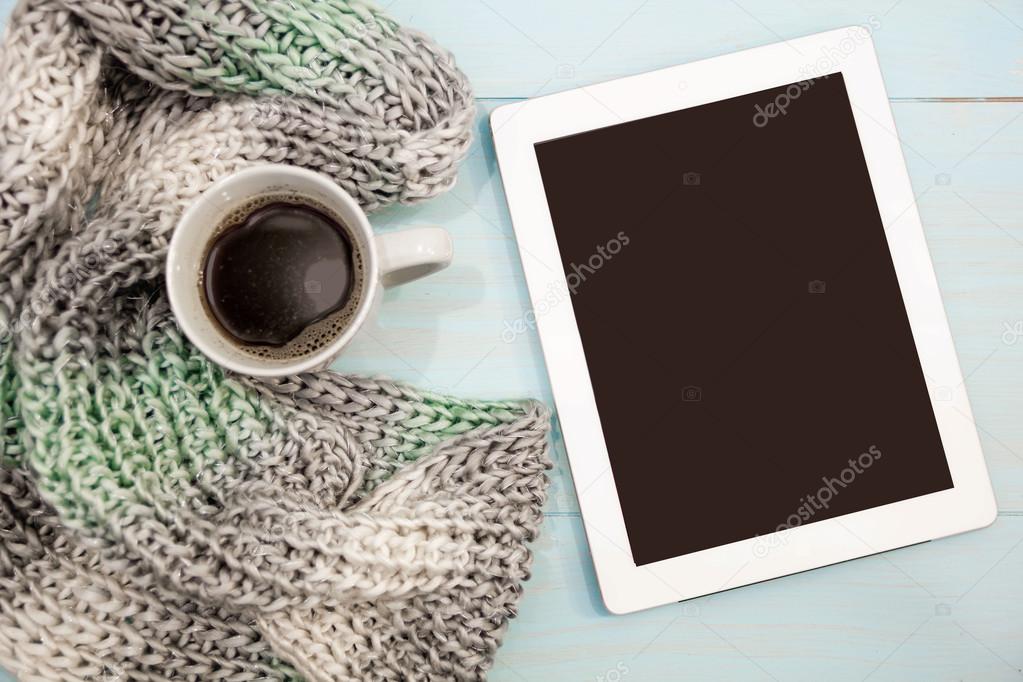 Cosy soft winter background, knitted sweater tablet Cup hot coffee old vintage wooden board. Christmas holidays at home. place for text, Top view, flat lay with copy space  slogan or  message