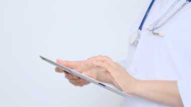 Modern dijital tablet kullanan beyaz önlüklü kadın doktor. Çevrimiçi tıbbi, sağlık veya tıbbi ağ konsepti. Tablet bilgisayar kullanan doktorun elleri