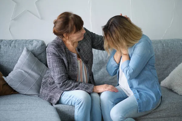 elderly mother hug crying adult daughter show support and care , supportive senior woman embrace cuddle grownup child feeling depressed, having life problems