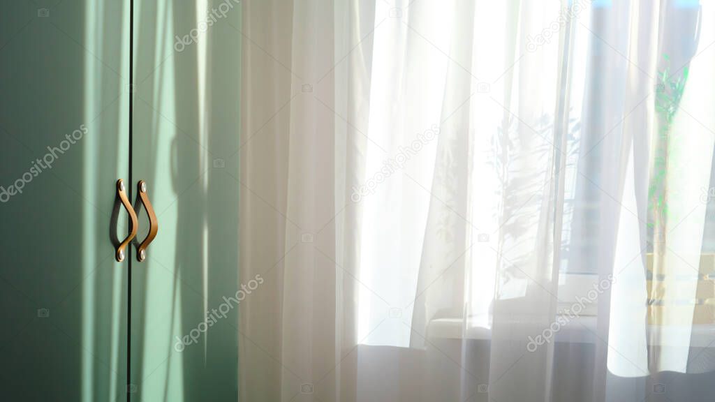 ray of sun light shines through transparent curtain from outdoor.