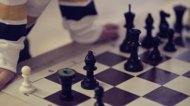 Küçük çocuk satranç oynuyor. çocuk el hareketi doğru hamle