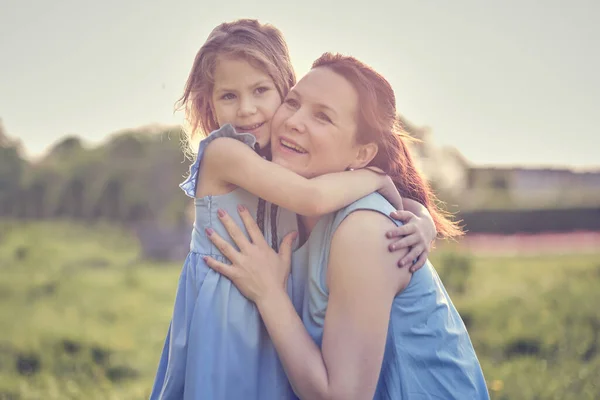 Natur scen med familj utomhus livsstil. Mor och dotter leker i en park. Lycklig familj koncept. Lycka och harmoni i familjelivet. — Stockfoto