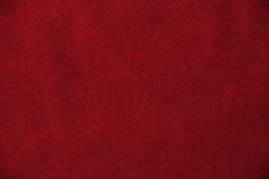 Örtülü kırmızı kadife arka planın soyut dokusu. Tekstil arka planı. Yakın plan. Üst görünüm