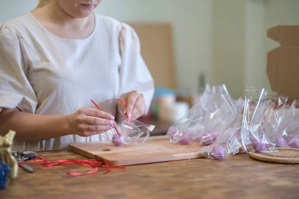 Woman entrepreneur packs the order in a beautiful box, perfect service for customers. — Stock Photo, Image