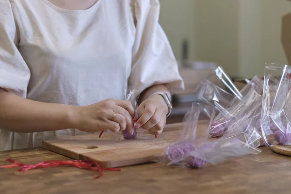 woman entrepreneur packs the order in a beautiful box, perfect service for customers.