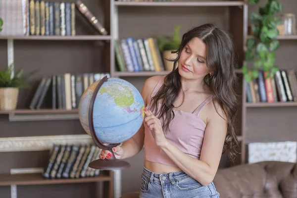 Portrait of a pretty mixed-race woman hand holding Earth globe model ball planning. Environmental Concept. World peace day and International day In the hands of earth. World Environment Day