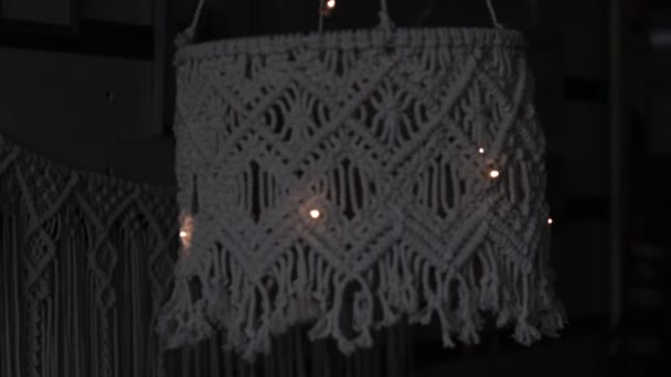 Handmade macrame lampshades hanging open design in natural colours.boho style shell shade For a lamp. on black background. Close up video. Slow motion video. stock footage. — Stock Video