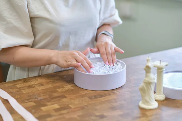 woman entrepreneur packs the order in a beautiful box, perfect service for customers.