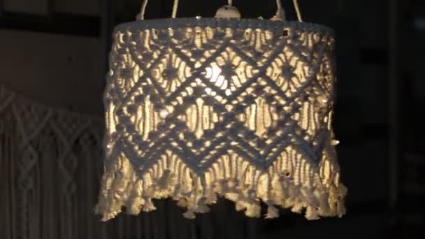 Handgefertigte Makramé-Lampenschirme mit offenem Design in natürlichen Farb.Boho-Stil Schirm Für eine Lampe. auf schwarzem Hintergrund. Video aus nächster Nähe. Zeitlupenvideo. Archivbild. — Stockvideo
