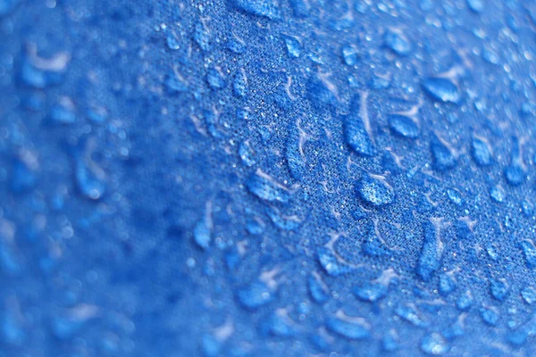 Water Proof Textile block water to pass through to stay dry. water beading on fabric. soft focus, blur